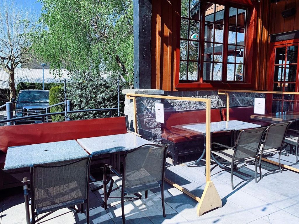An outdoor patio with tables and chairs