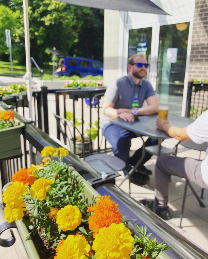 People eating on a patio with flowers